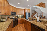 Experience rustic charm in this spacious kitchen featuring warm, knotty pine cabinetry and stunning granite countertops.