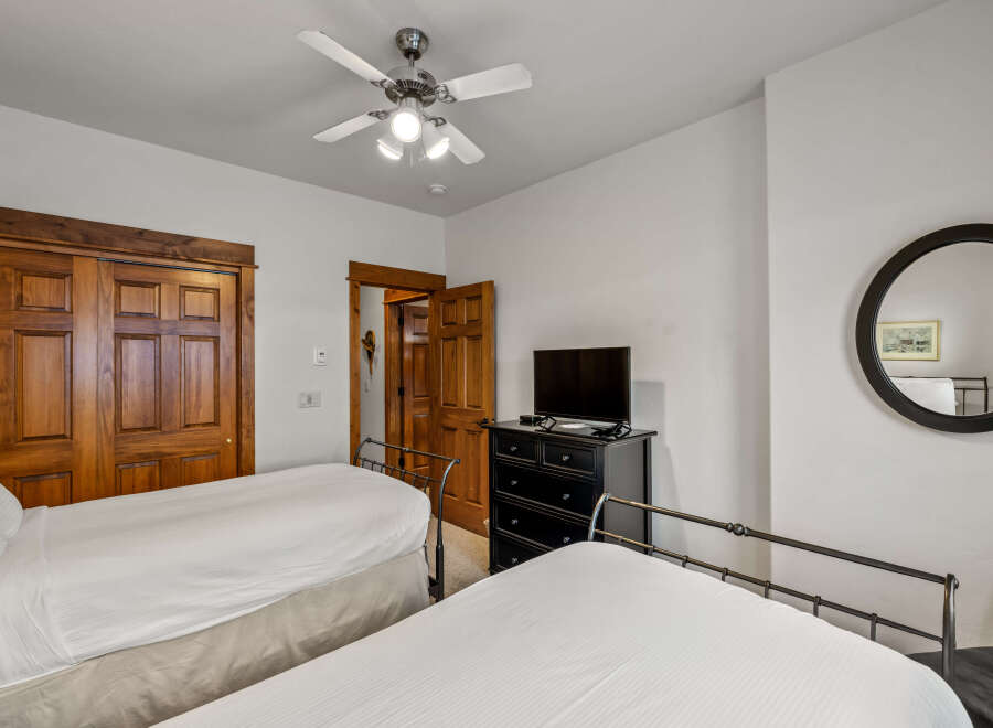 This charming bedroom features two comfortable beds with crisp white linens, perfect for a restful night's sleep.