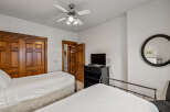 This charming bedroom features two comfortable beds with crisp white linens, perfect for a restful night's sleep.