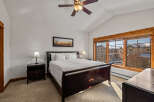 Experience comfort and style in this inviting bedroom, featuring a plush king-sized bed and elegant dark wood furniture.