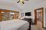 Experience mountain living in this charming bedroom featuring a spacious king-size bed and a private ensuite bathroom.