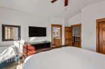 This inviting bedroom features a spacious king-sized bed with crisp white linens, perfect for a restful night's sleep.