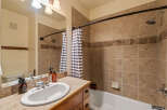 This bathroom features a spacious vanity with a double sink and ample counter space, perfect for morning routines.