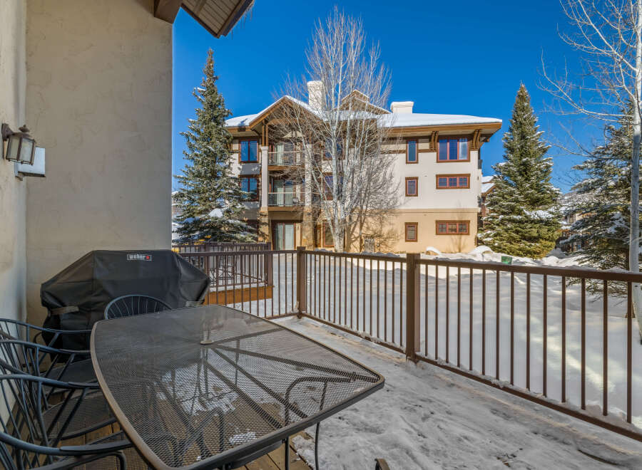 Enjoy breathtaking mountain views from this charming balcony, complete with a Weber grill for outdoor cooking.