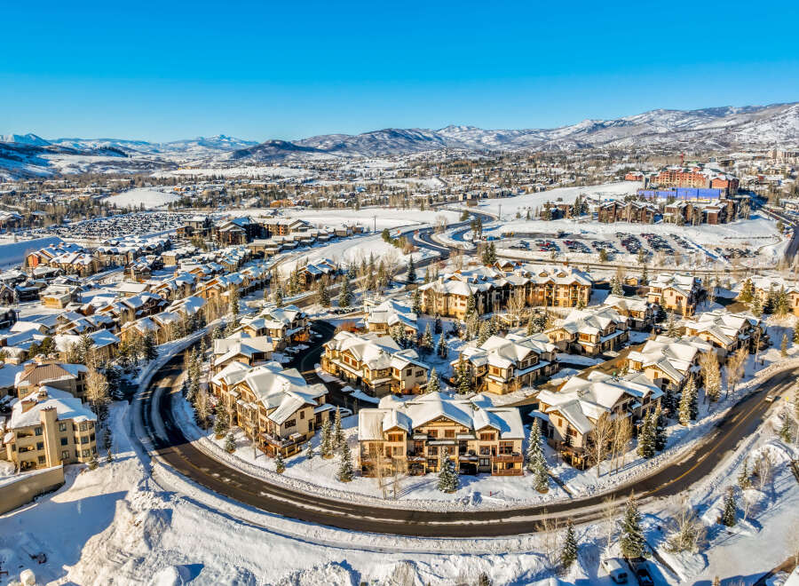 Experience luxury mountain living in this stunning ski resort community, featuring charming chalets and condos blanketed in fresh snow.
