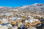 Experience luxury mountain living in this stunning ski resort town, featuring charming townhomes blanketed in fresh snow.