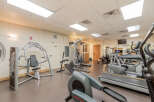 This well-equipped fitness center offers a variety of cardio machines, including treadmills and ellipticals, alongside strength training equipment for a complete workout.