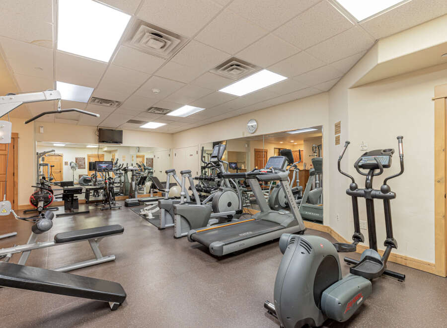 This well-equipped gym features a variety of cardio machines including treadmills and ellipticals, perfect for maintaining your fitness routine.