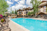 Enjoy a refreshing dip in the sparkling blue pool, surrounded by comfortable lounge chairs perfect for soaking up the sun.