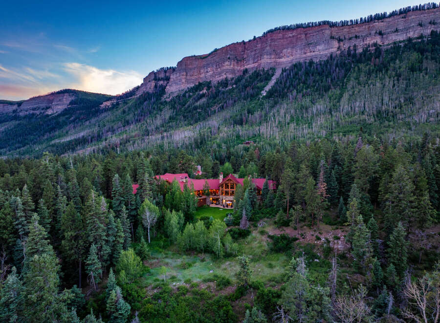 Nestled amidst a dense forest and beneath a majestic mountain range, this stunning luxury estate offers unparalleled privacy and breathtaking natural beauty.