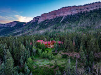 Nestled amidst a dense forest and beneath a majestic mountain range, this stunning luxury estate offers unparalleled privacy and breathtaking natural beauty.