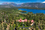Experience luxury living in this stunning mountain estate, nestled amidst a lush pine forest with breathtaking views of a serene lake and majestic peaks.