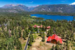 Experience luxury mountain living in this stunning estate, nestled amidst a dense pine forest with breathtaking views of a serene lake and majestic mountains.