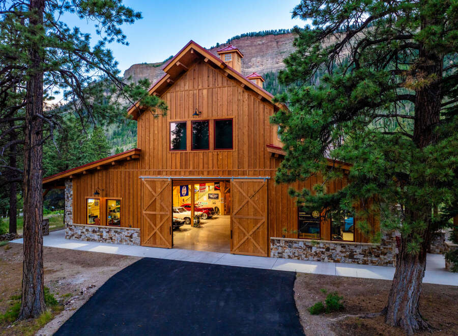 Experience the ultimate mountain lifestyle in this stunning custom-built barn, perfect for car enthusiasts and outdoor adventurers.