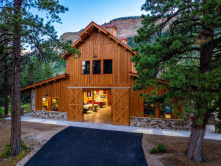 Experience the ultimate mountain lifestyle in this stunning custom-built barn, perfect for car enthusiasts and outdoor adventurers.