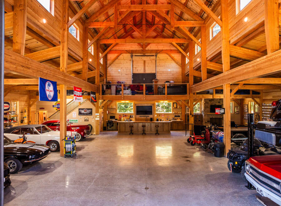 Experience the ultimate automotive enthusiast's dream in this stunning timber-frame garage.