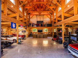 Experience the ultimate automotive enthusiast's dream in this stunning timber-frame garage.