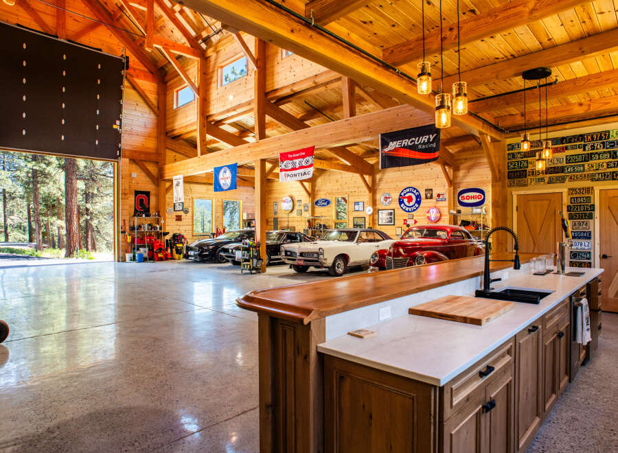Experience the ultimate automotive enthusiast's dream in this stunning garage, featuring a pristine collection of classic and modern cars.