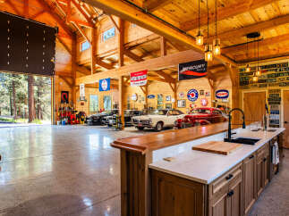 Experience the ultimate automotive enthusiast's dream in this stunning garage, featuring a pristine collection of classic and modern cars.