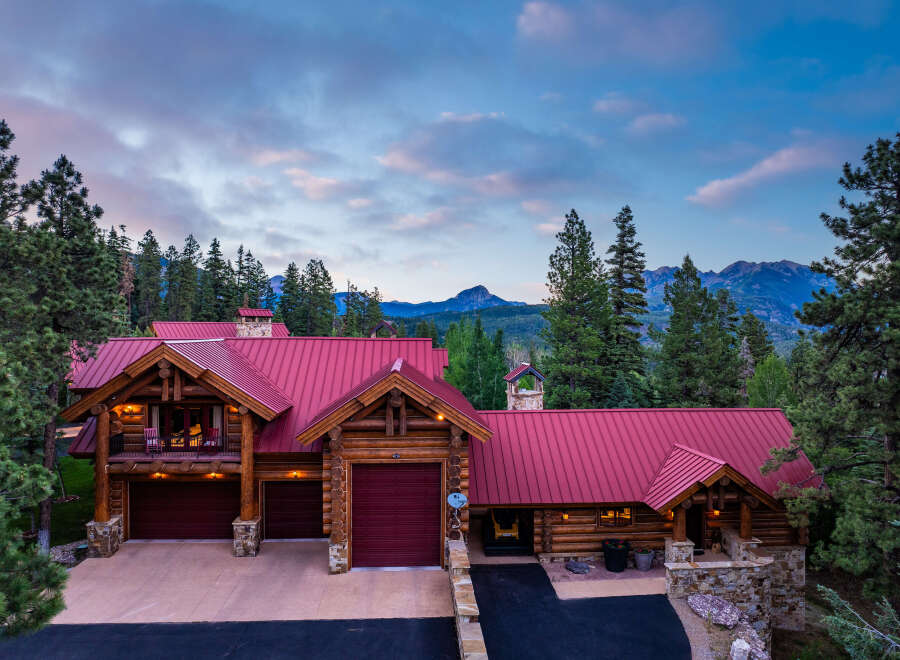 Experience the ultimate mountain retreat in this stunning log home, nestled amidst towering pine trees and offering breathtaking views of distant peaks.
