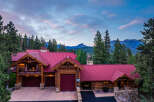 Experience the ultimate mountain retreat in this stunning log home, nestled amidst towering pine trees and offering breathtaking views of distant peaks.