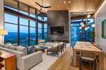 Experience luxury living with this stunning open-concept great room, featuring a dramatic floor-to-ceiling fireplace and expansive windows that frame breathtaking mountain views.