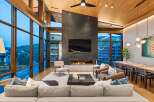 Experience luxury living in this stunning modern great room, featuring floor-to-ceiling windows that offer breathtaking mountain views.