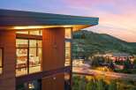 Experience modern luxury living with stunning mountain views at dusk.