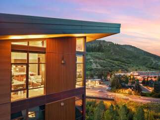 Experience modern luxury living with stunning mountain views at dusk.