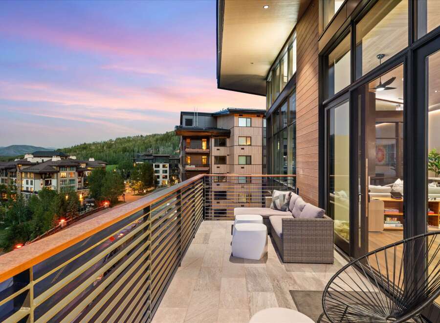 Experience luxury living with this stunning balcony view, perfect for enjoying breathtaking sunsets over the mountains.