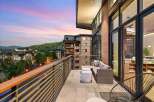 Experience luxury living with this stunning balcony view, perfect for enjoying breathtaking sunsets over the mountains.
