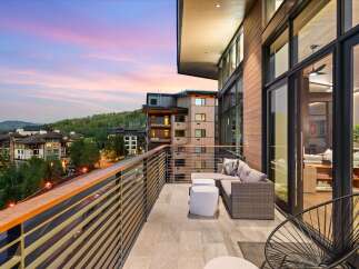 Experience luxury living with this stunning balcony view, perfect for enjoying breathtaking sunsets over the mountains.