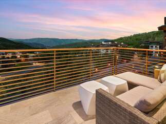 Experience breathtaking mountain views from this stunning balcony, perfect for enjoying serene sunsets.