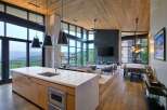 Experience luxury mountain living in this stunning open-concept home, featuring a gourmet kitchen with a waterfall island and sleek cabinetry.