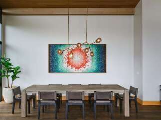 Experience sophisticated dining in this elegant space, featuring a large, rustic wooden table complemented by modern upholstered chairs.