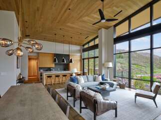 Experience luxury living in this stunning open-concept home, featuring a gourmet kitchen with a waterfall island and sleek cabinetry.
