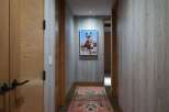 This hallway features a striking portrait of a donkey, adding a unique artistic touch to the space.