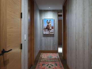 This hallway features a striking portrait of a donkey, adding a unique artistic touch to the space.