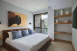Experience luxurious mountain living in this stunning bedroom, featuring a striking bison artwork above a plush leather bed.
