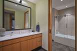 This modern bathroom features a sleek vanity with ample storage and a clean white countertop.