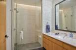 Experience modern luxury in this stunning bathroom featuring a spacious glass-enclosed shower with elegant tilework.
