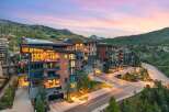 Experience luxury mountain living in this stunning contemporary condominium complex, nestled against a backdrop of majestic peaks.