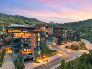 Experience luxury mountain living in this stunning contemporary condominium complex, nestled against a backdrop of majestic peaks.