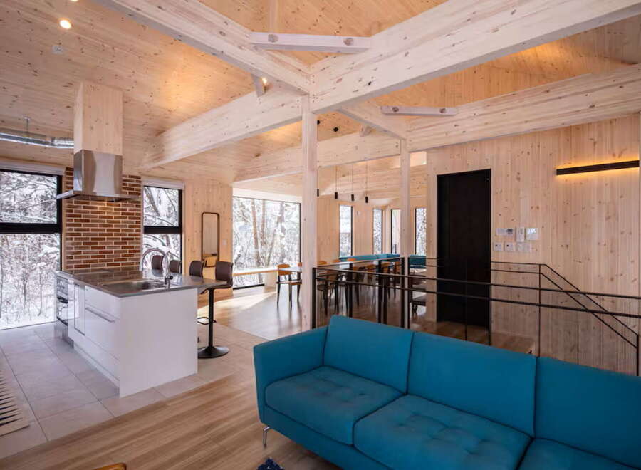Experience modern living in this stunning open-concept home featuring a sleek kitchen island with a waterfall countertop and a spacious living area.