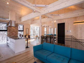 Experience modern living in this stunning open-concept home featuring a sleek kitchen island with a waterfall countertop and a spacious living area.