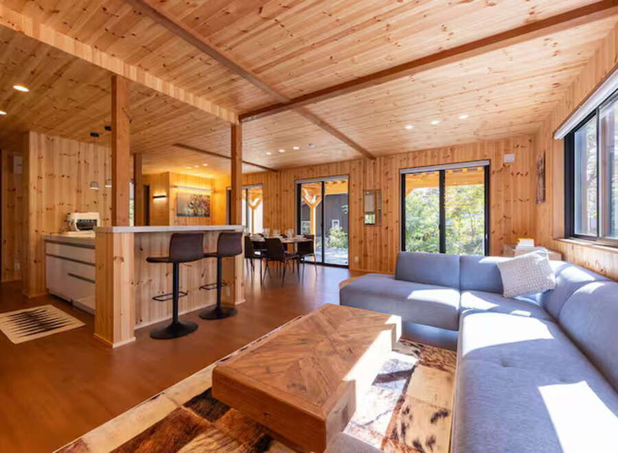 Experience modern living in this stunning wood-paneled home, featuring an open-concept living and dining area perfect for entertaining.