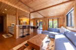 Experience modern living in this stunning wood-paneled home, featuring an open-concept living and dining area perfect for entertaining.