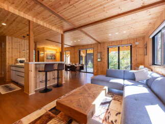 Experience modern living in this stunning wood-paneled home, featuring an open-concept living and dining area perfect for entertaining.