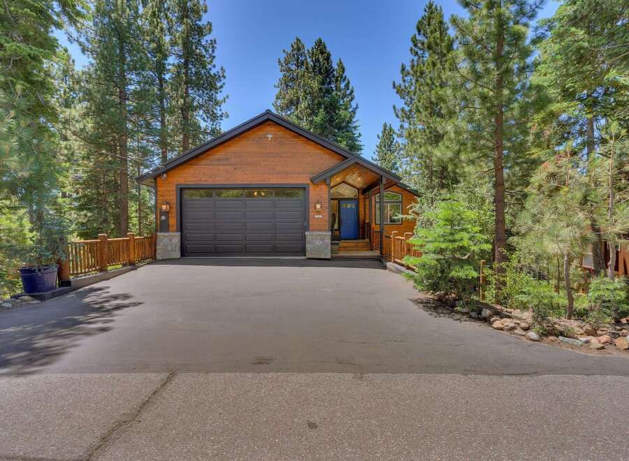 Nestled among tall pine trees, this charming wooden home offers a picturesque mountain retreat.