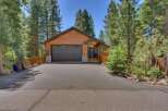 Nestled among tall pine trees, this charming wooden home offers a picturesque mountain retreat.